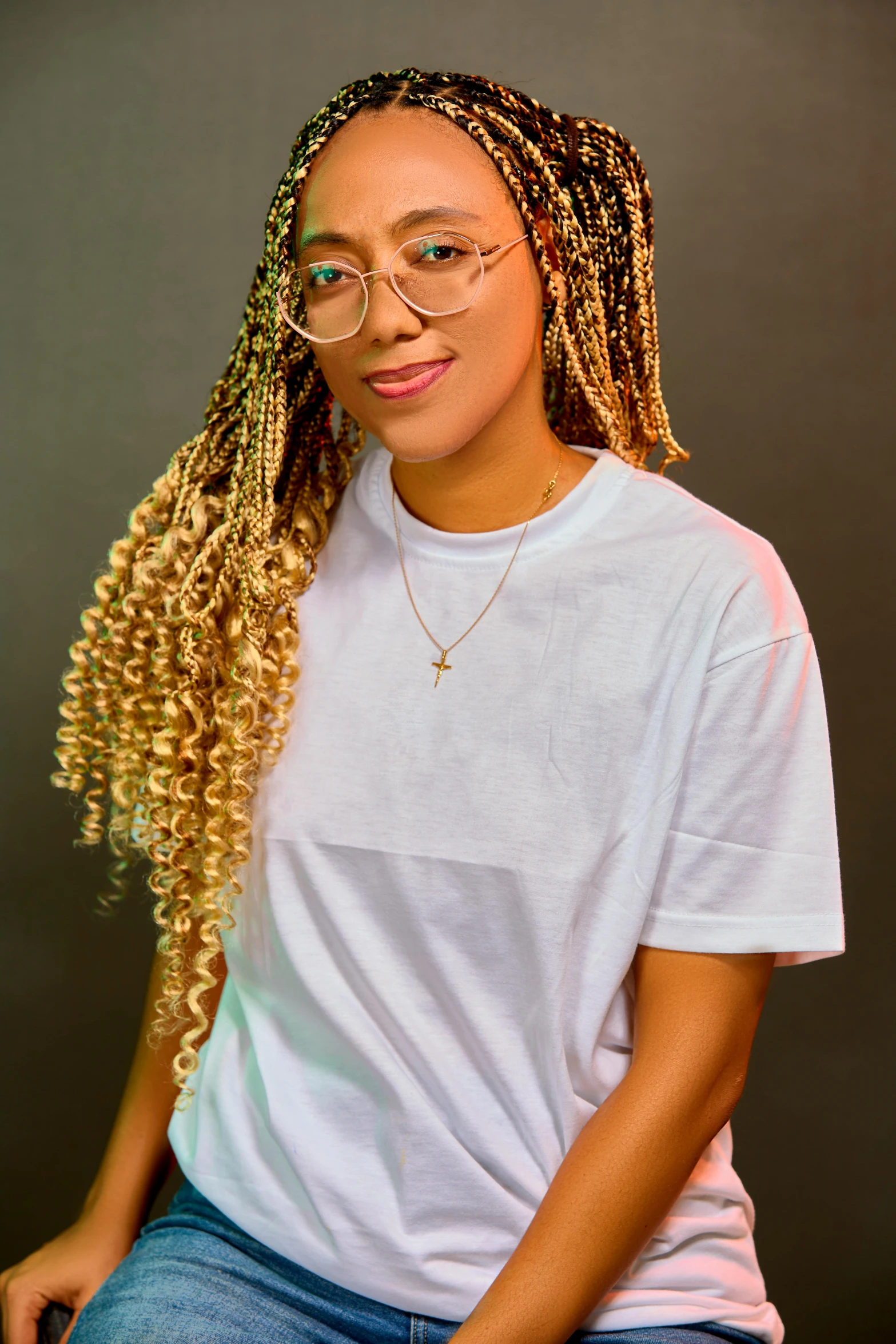 a woman in glasses and long hair is posing for the camera