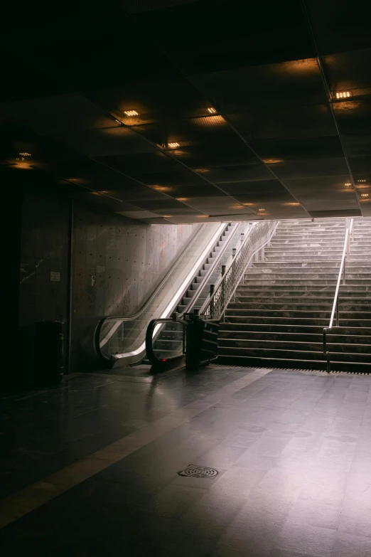 two escalators are positioned next to an open stairwell