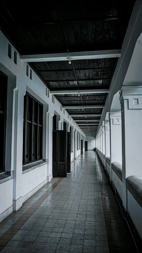 a long row of white benches underneath a ceiling