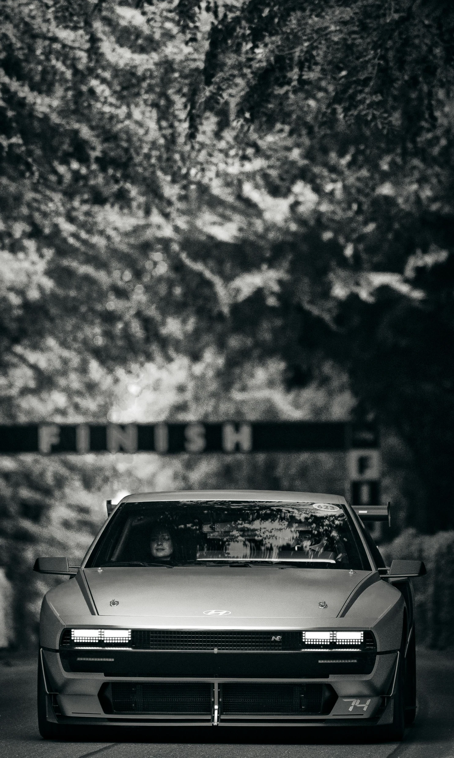 the front view of a car is shown in black and white