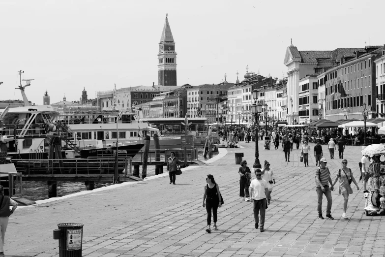 a black and white po of many people walking on the road