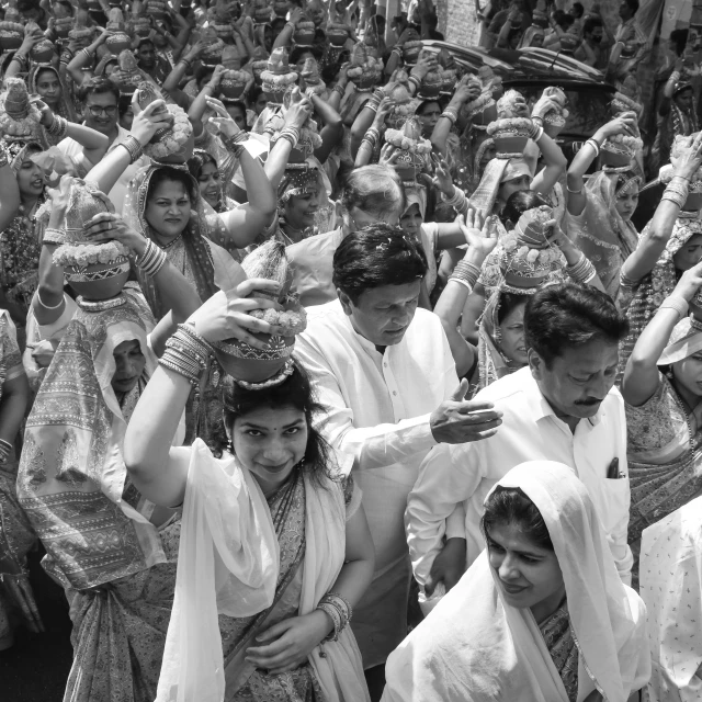 many people dressed in traditional indian dress waving