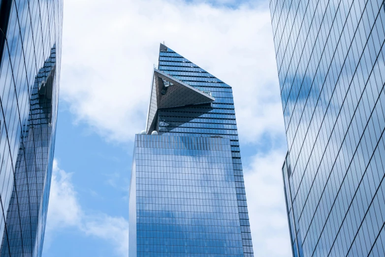 looking up at two large blue skyscrs in the city