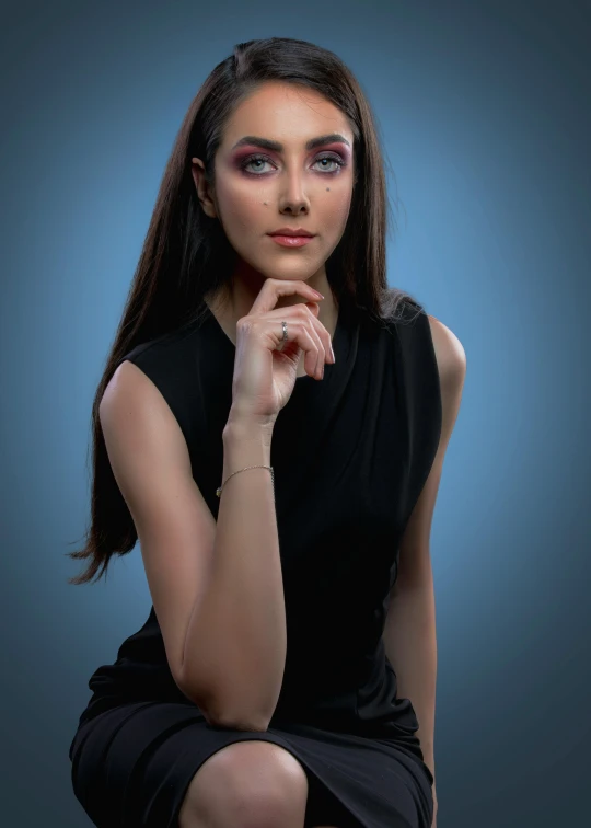 a woman with makeup and eyeshadow sitting down