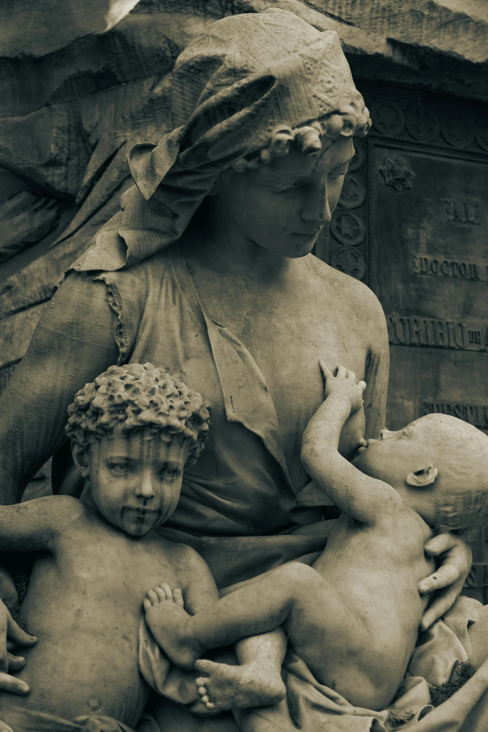 a statue with an infant child sitting between them on the back