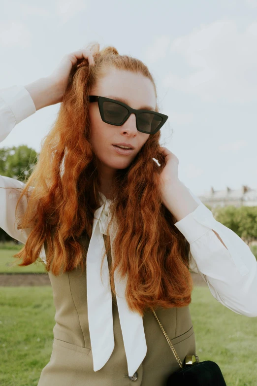 the woman is wearing shades and has long hair