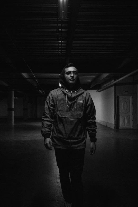 a man standing alone in a darkened area