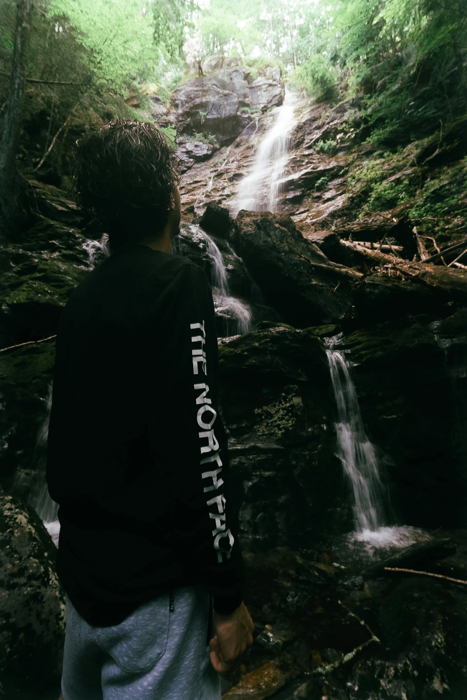 a  watches a waterfall from the ground