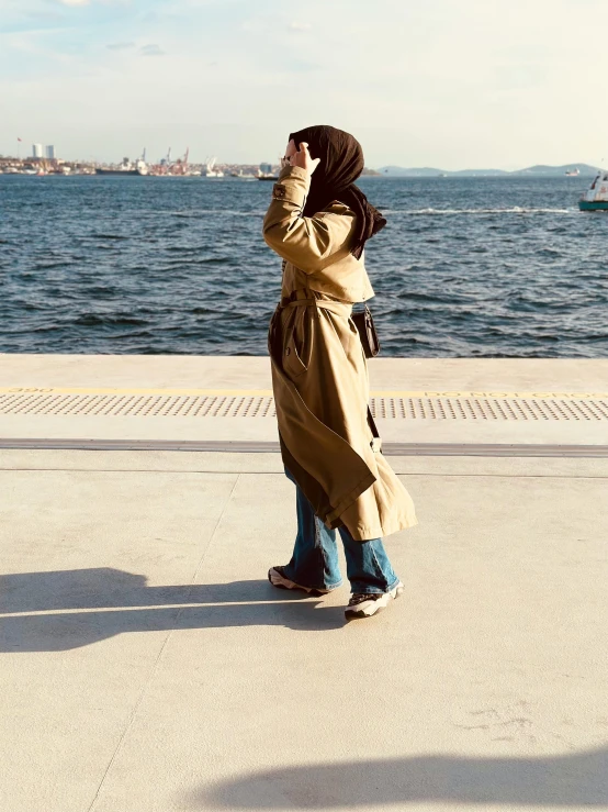 a young woman takes a picture in the water