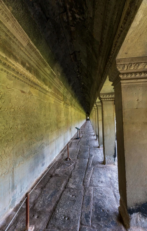 an empty room with cement lined walls and several benches