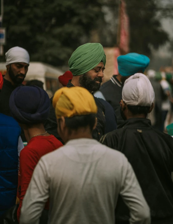 many people wearing turbans standing next to each other