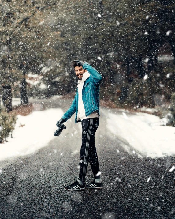 the man is standing on a snowboard in the snow