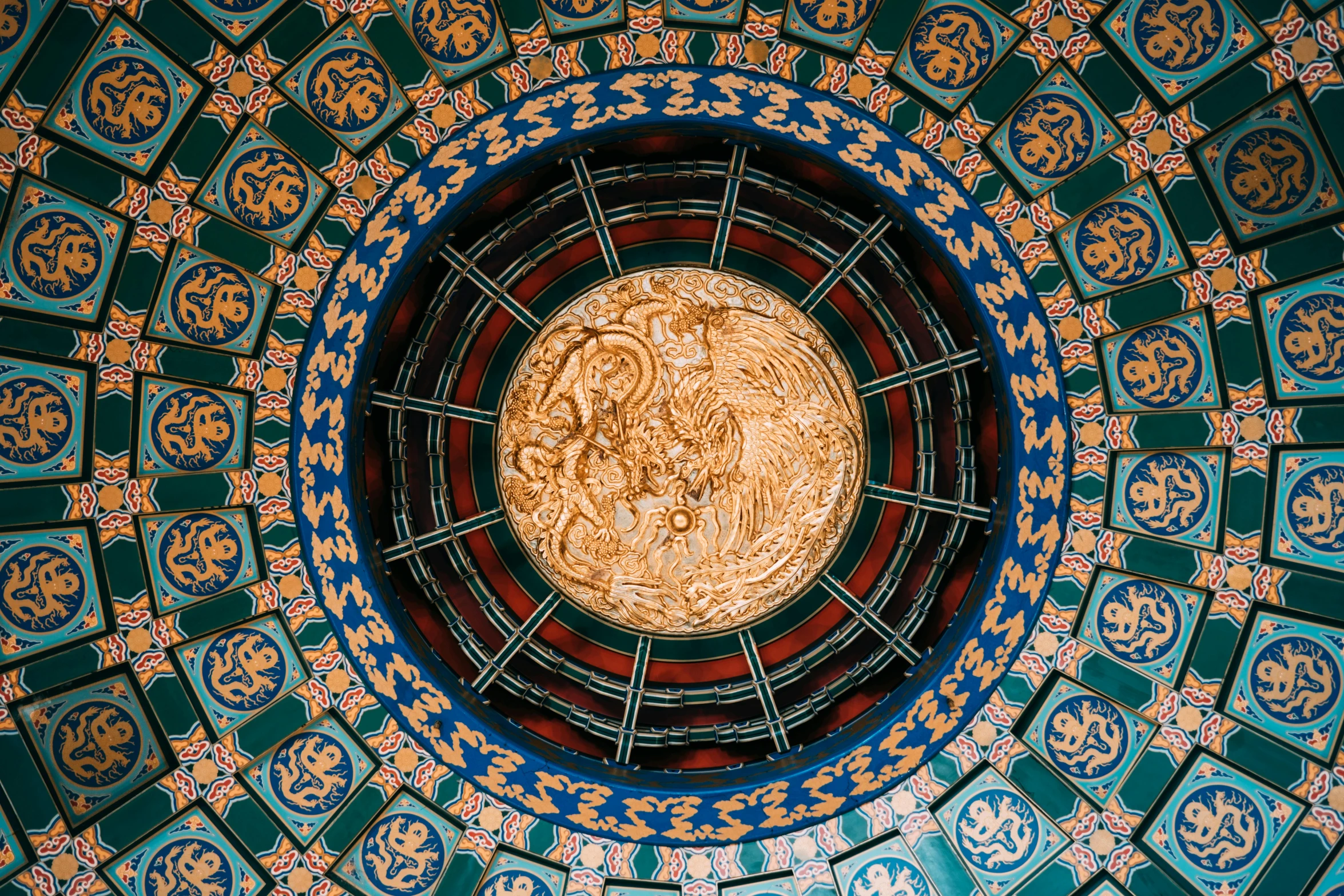 an intricately designed ceiling with a circular circular window