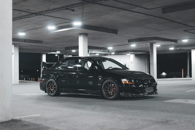 a black car parked in the parking garage