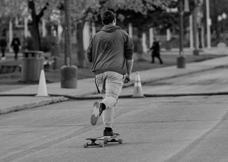 a person walking down the road on a skateboard