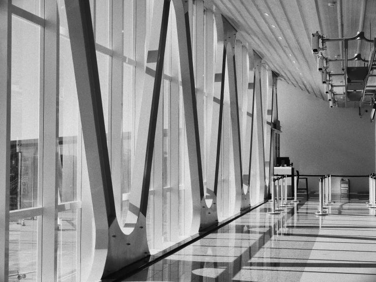 the long hallway of a building with multiple pillars