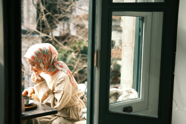 a woman sitting at a table with a tray of food