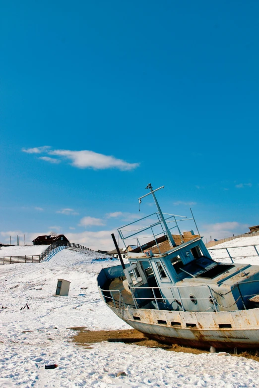 a boat sitting on top of a sandy beach