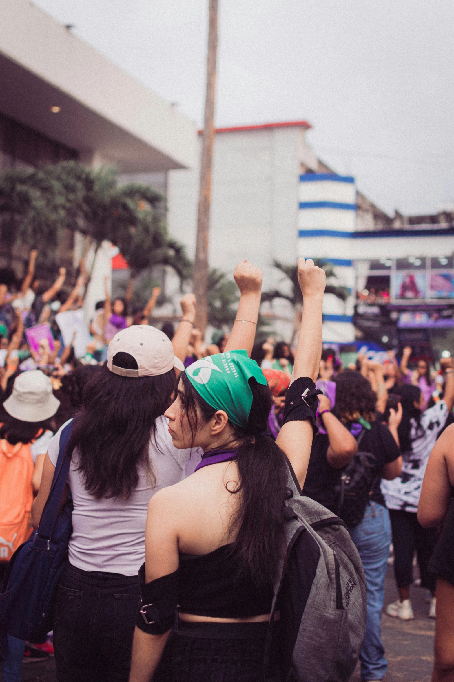 two women emcing in a crowd with some people cheering