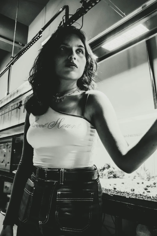 black and white image of woman wearing skirt next to tank top