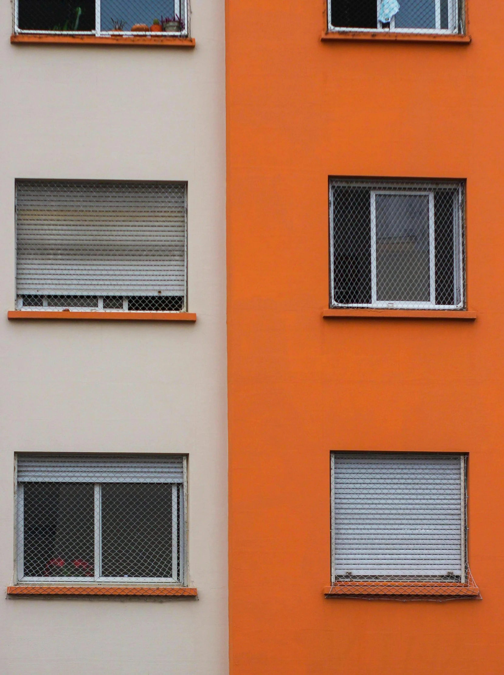 some orange and white windows a clock and a building