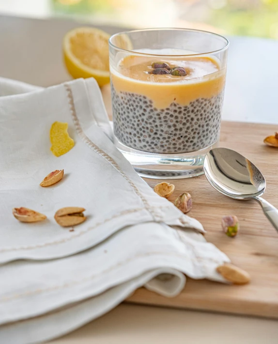 a glass and spoon are next to some food