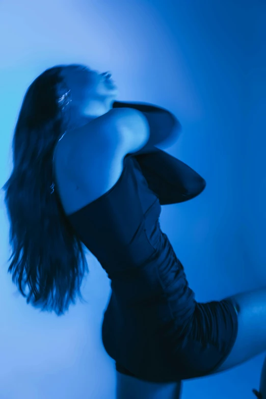 a woman with long hair in a black dress