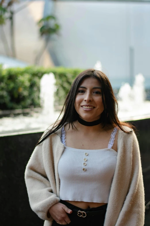 a beautiful woman in a white top and a coat