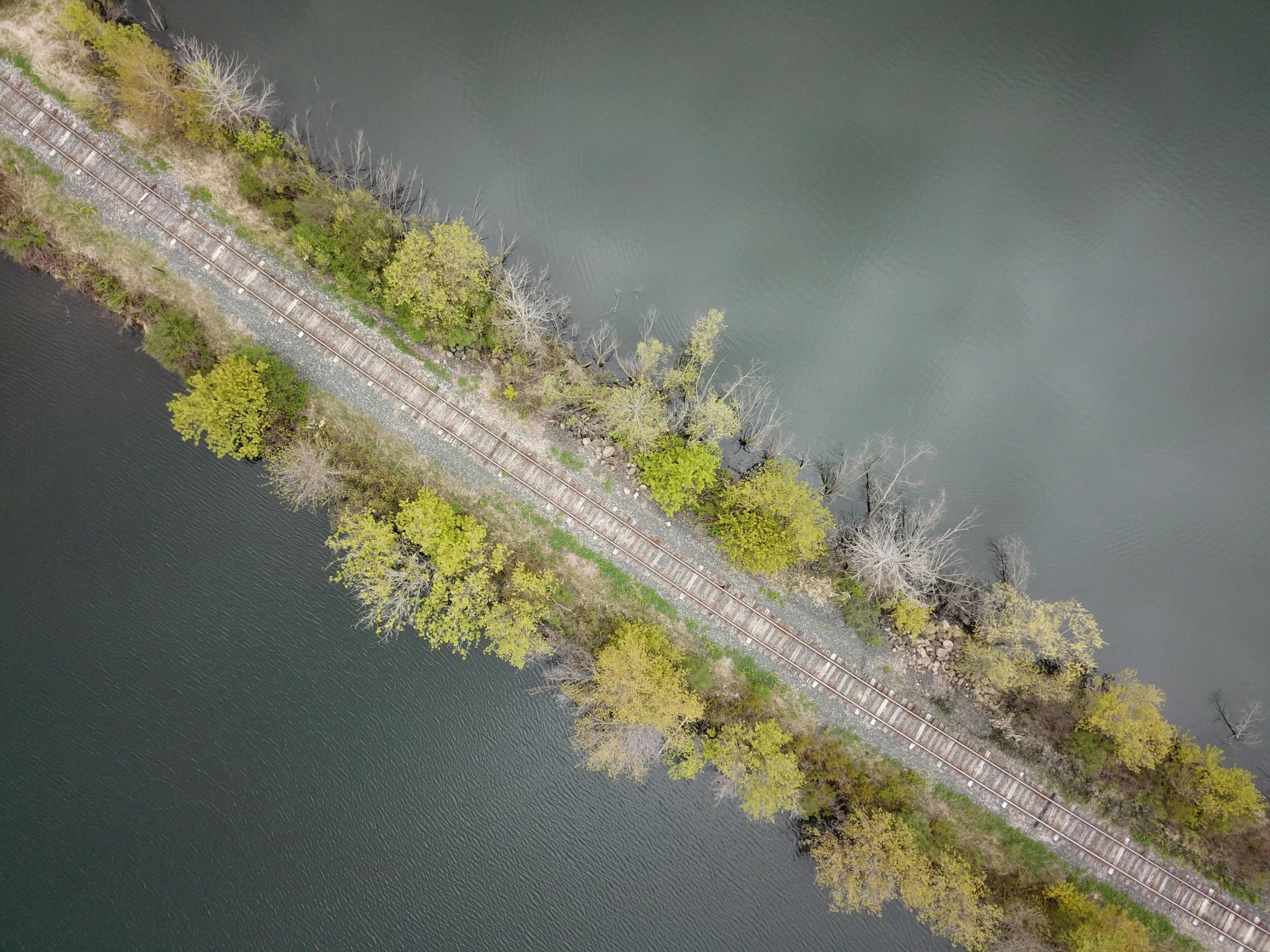 an aerial po of a railway crossing across a river