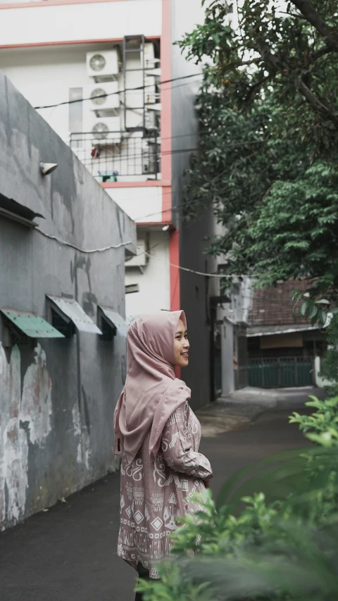 the woman is walking on the street next to a building