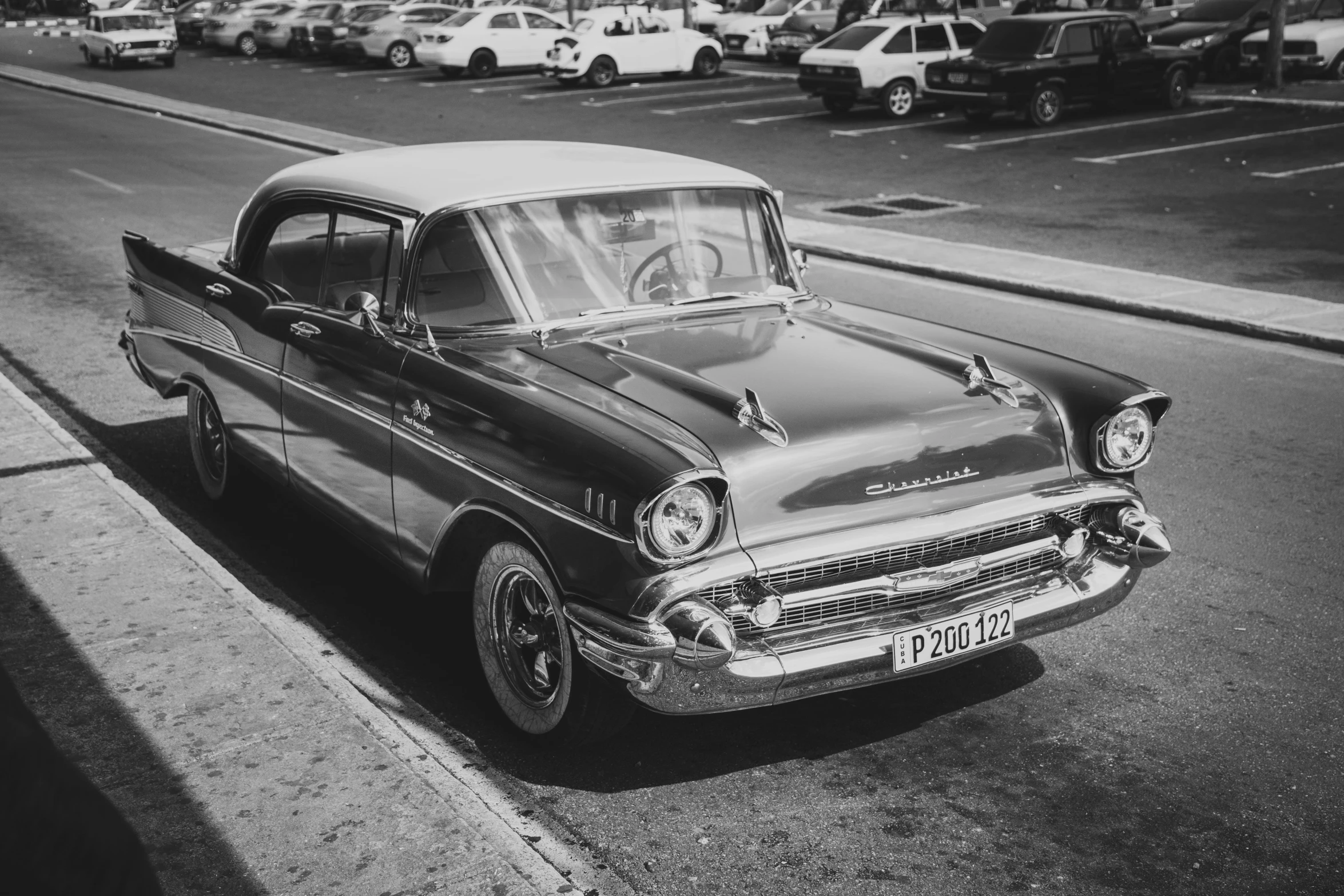 a black and white po of a classic car on the side of the road