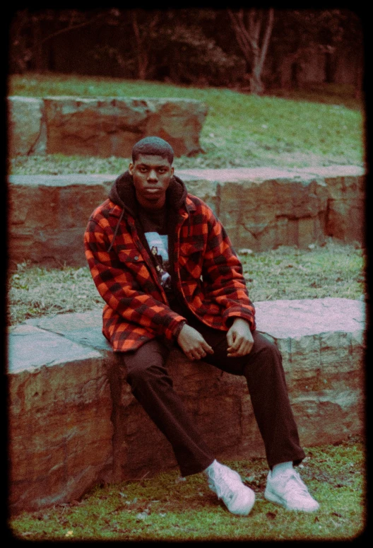 the man is sitting on steps in the park