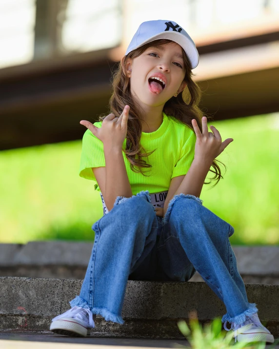 a girl in a green shirt and blue jeans