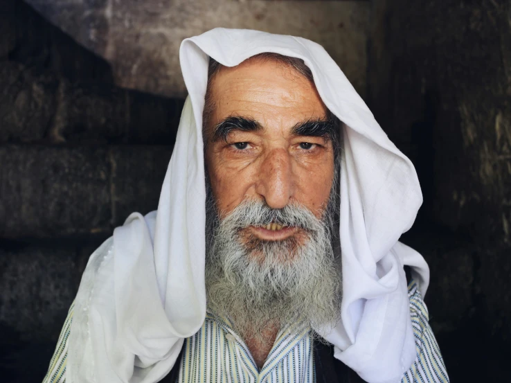 a man with a beard and white veil