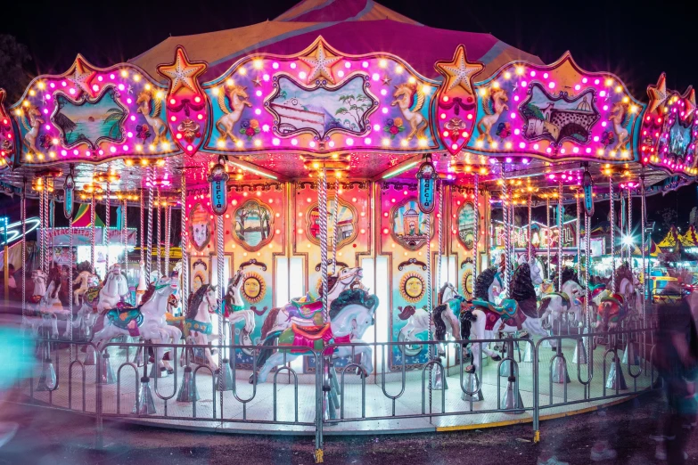 a brightly lit merry go round with horses