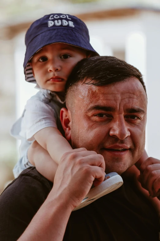 a man holding a boy in his arms