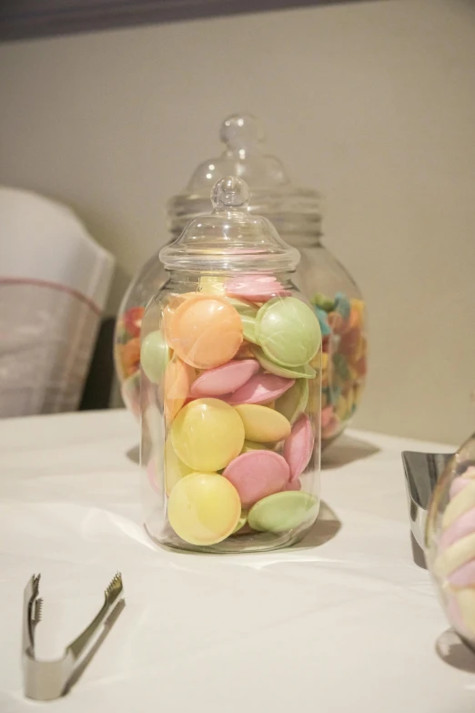 a glass jar filled with assorted candy candies