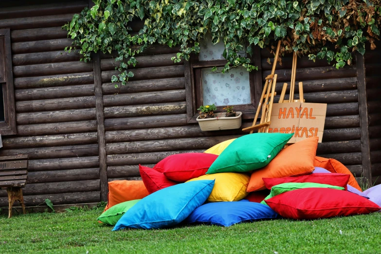 a group of pillows stacked together on the grass