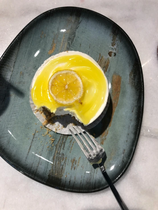 an orange and egg mixture in a ed plate on top of a table