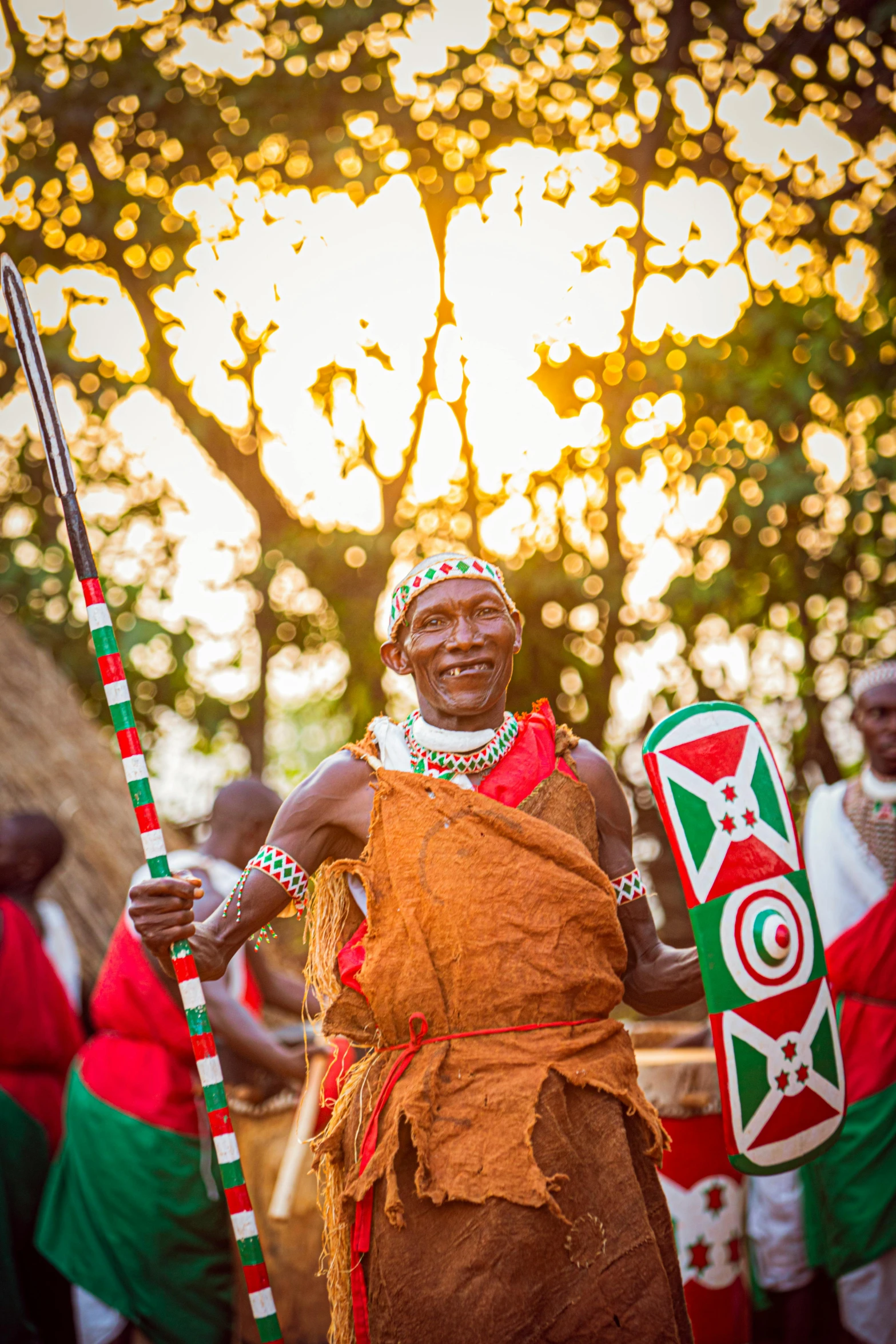 an african man in brown and green outfit