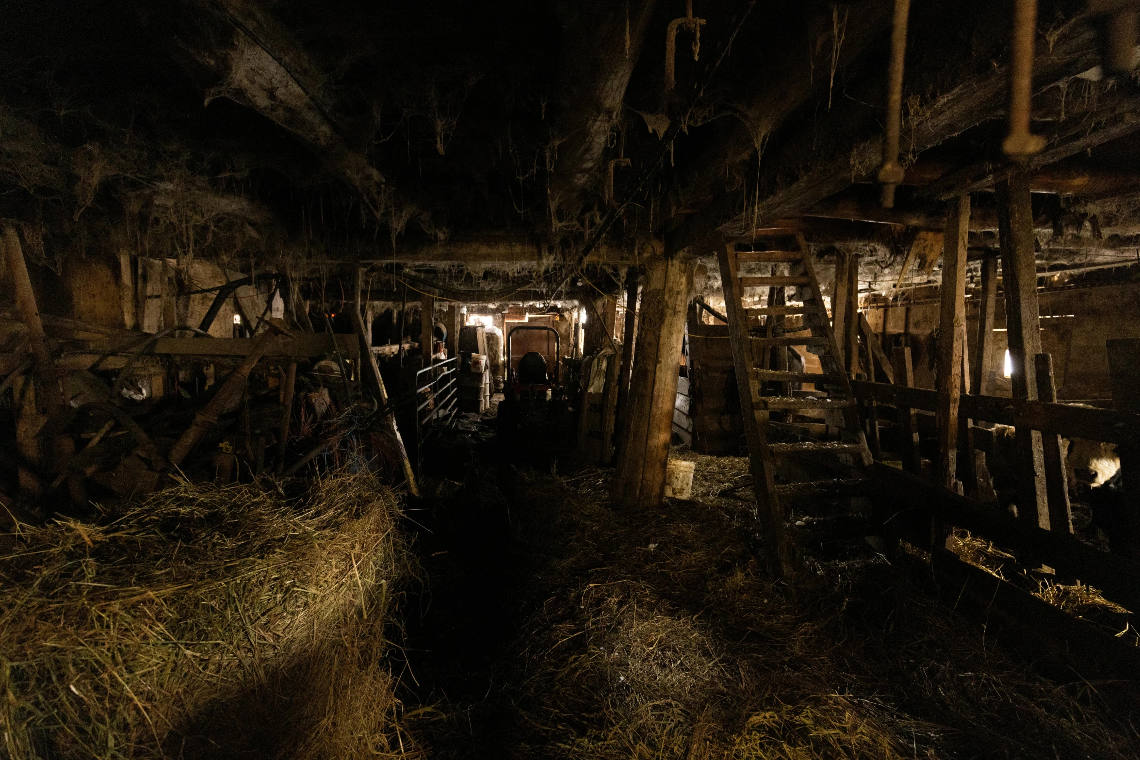 a dark scene with beams and logs sticking out of the ground