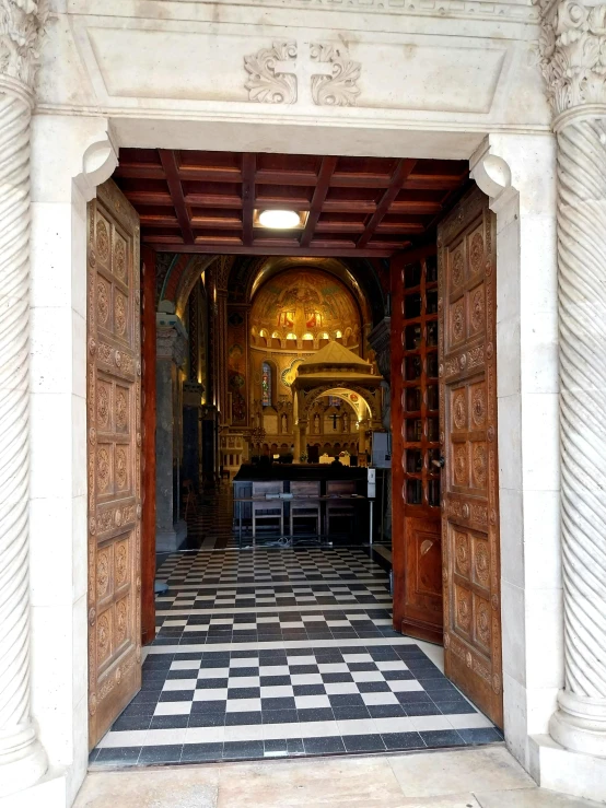 an empty, historic, ornate entry way to the church