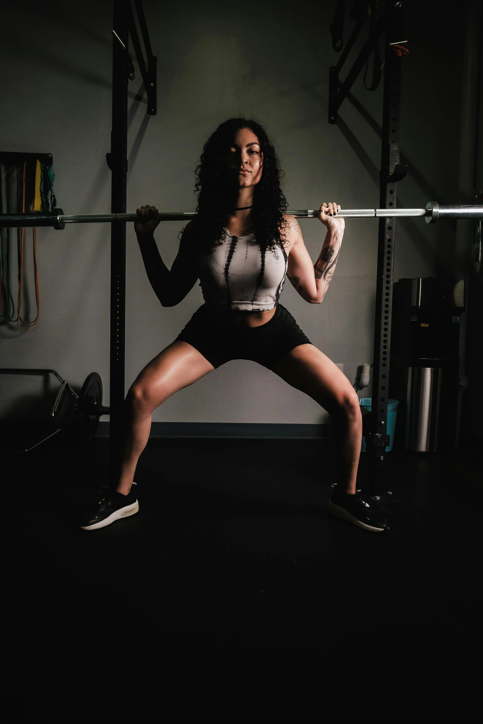 a woman is squatting up to do a h - up