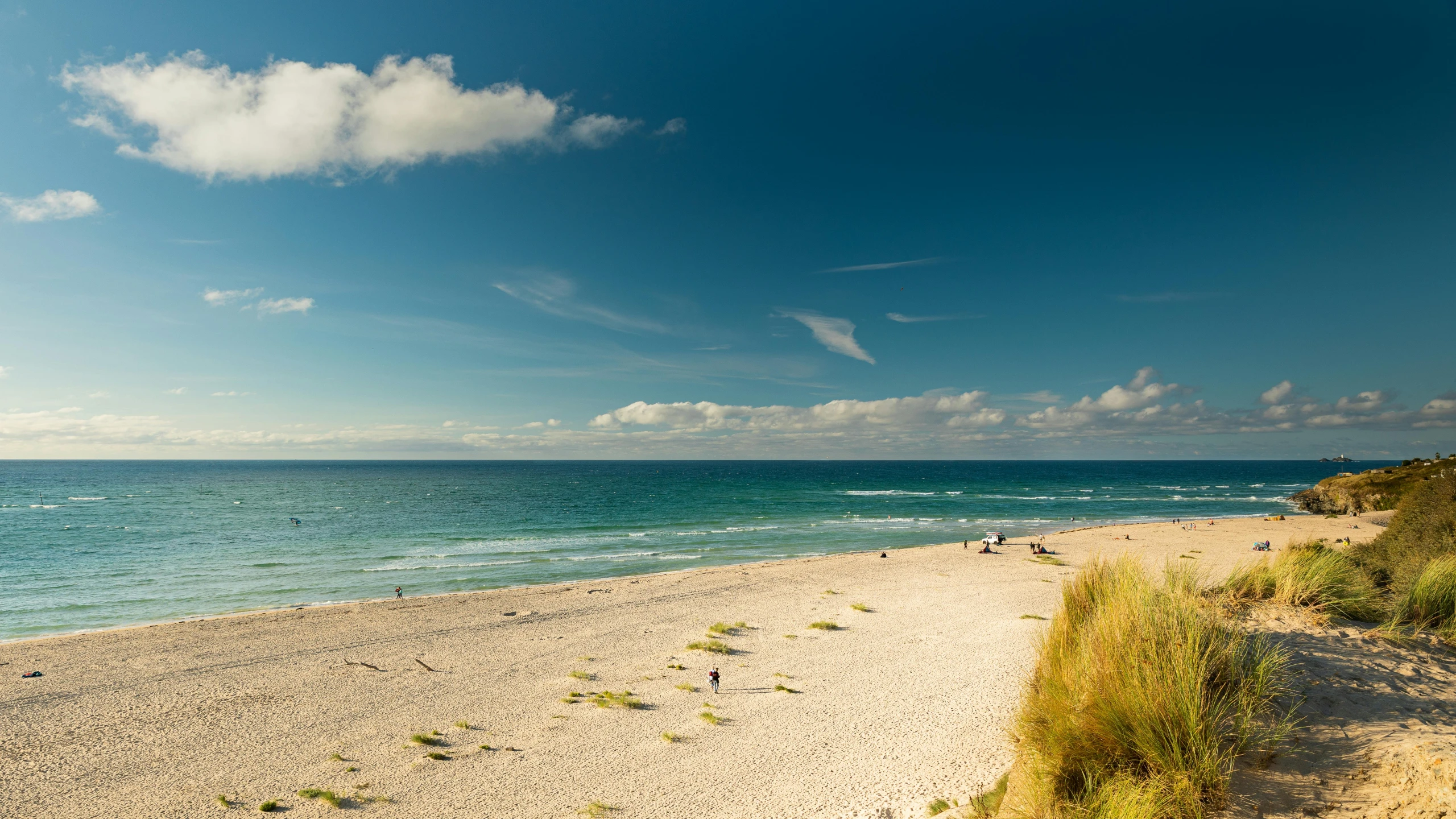 an empty beach is in front of a vast expanse of ocean water