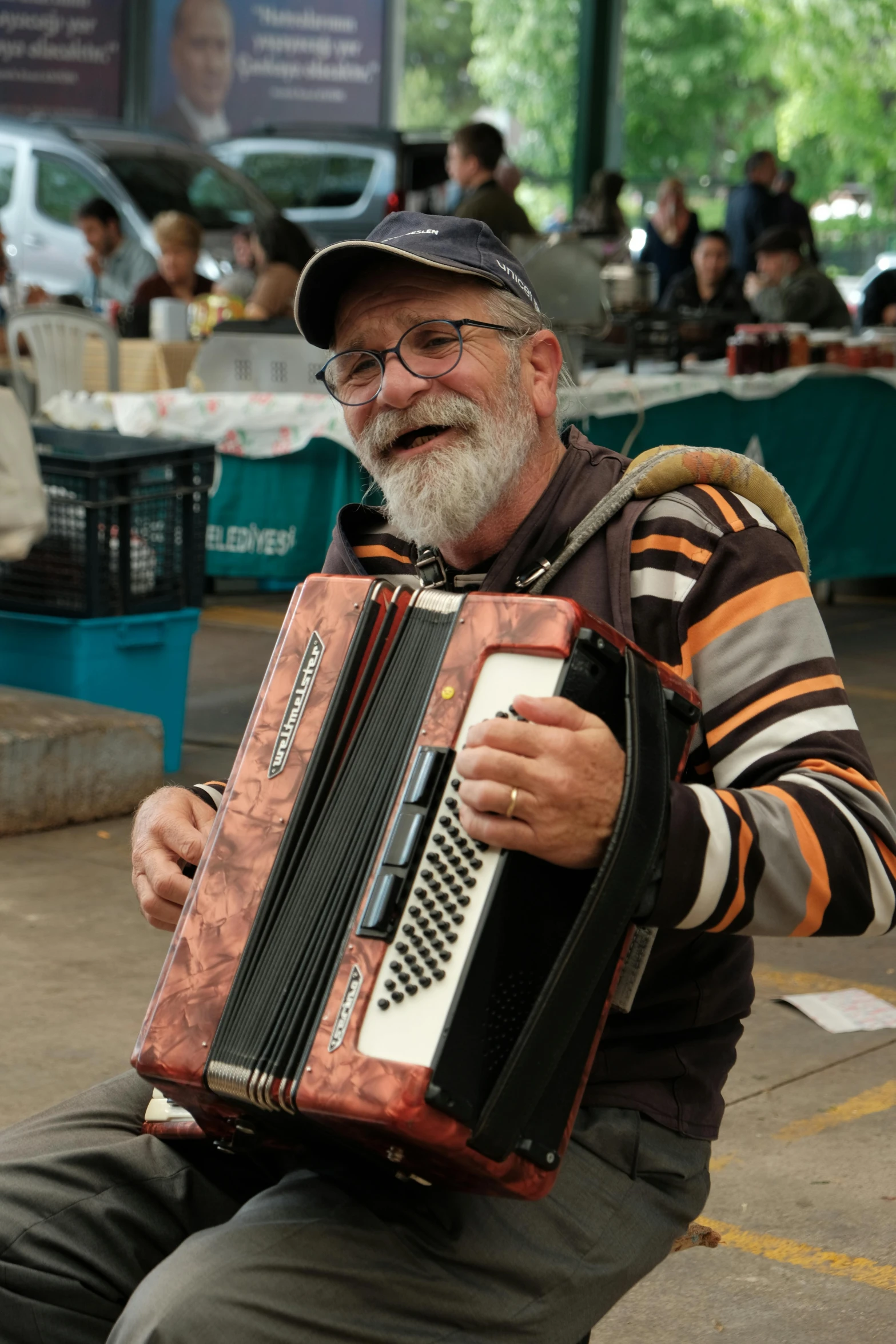 a man that is sitting down holding an instrument