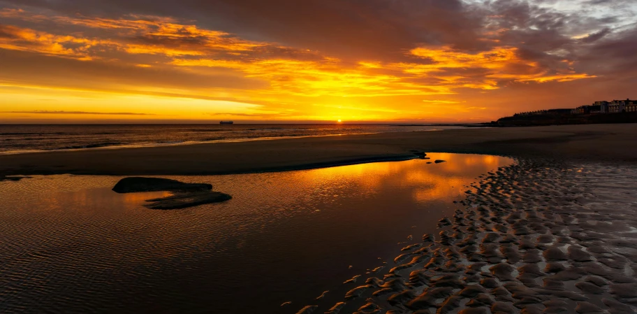 an amazing sunset on the beach from a nearby shore