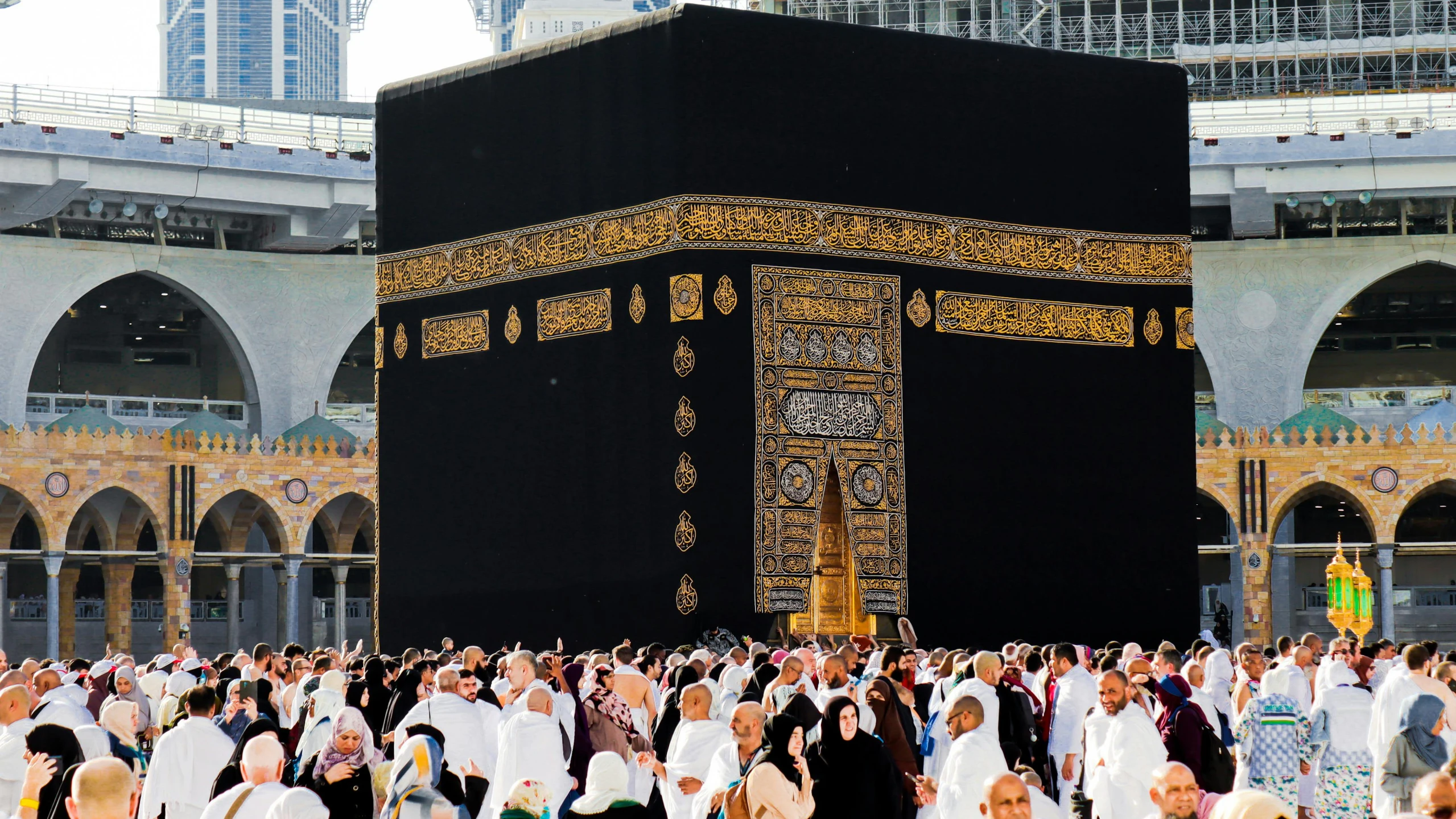 many people gather around a huge object inside a city