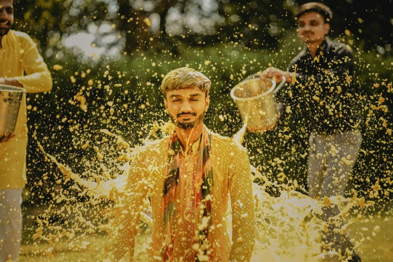 a man covered in water has his face covered with spray