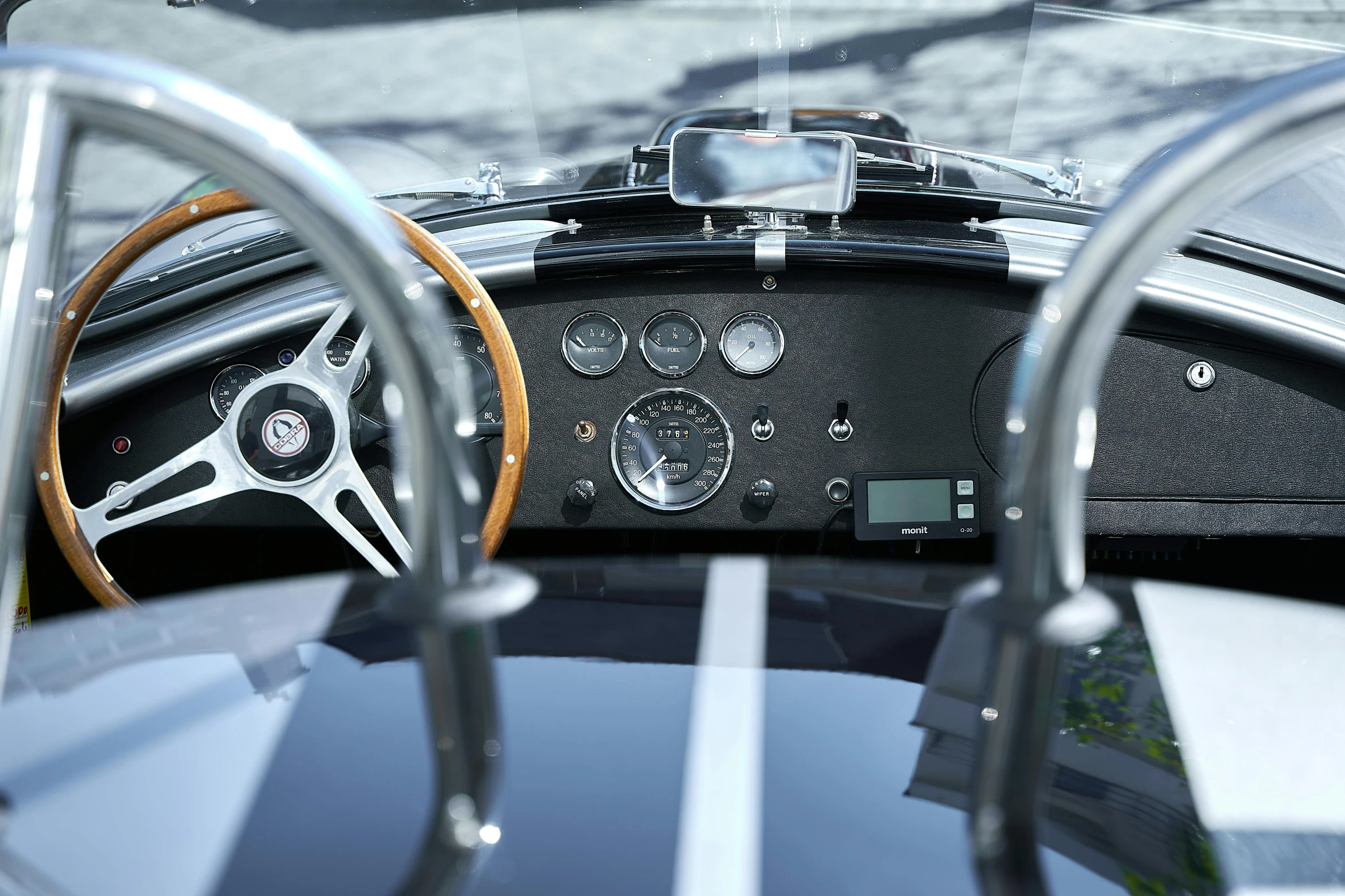 an image of a black car dashboard with an older one