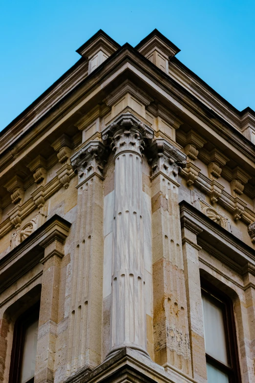 a close up of a large stone building with pillars